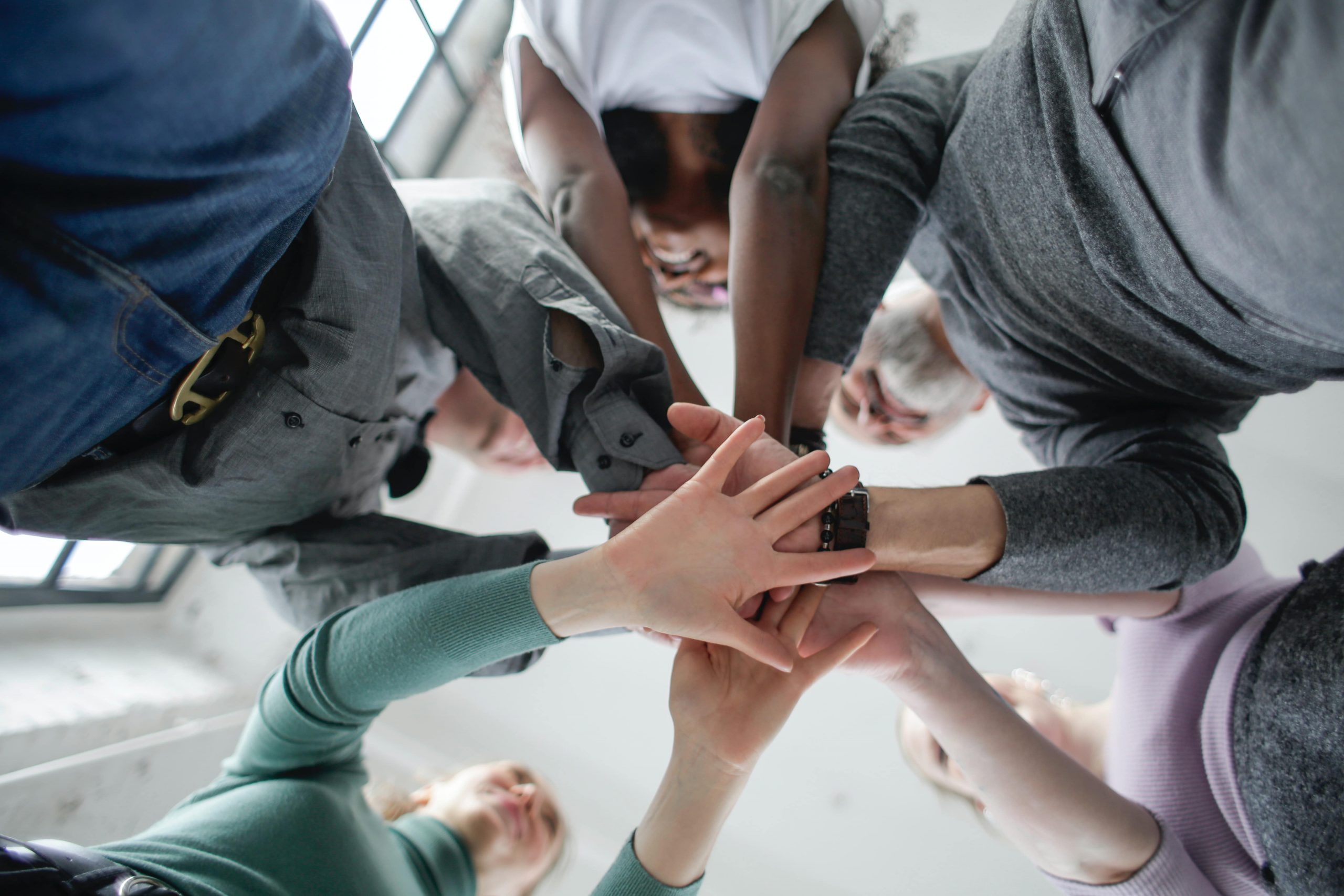 low-angle-photo-of-people-holding-hands-together-3931604-copy-min-scaled